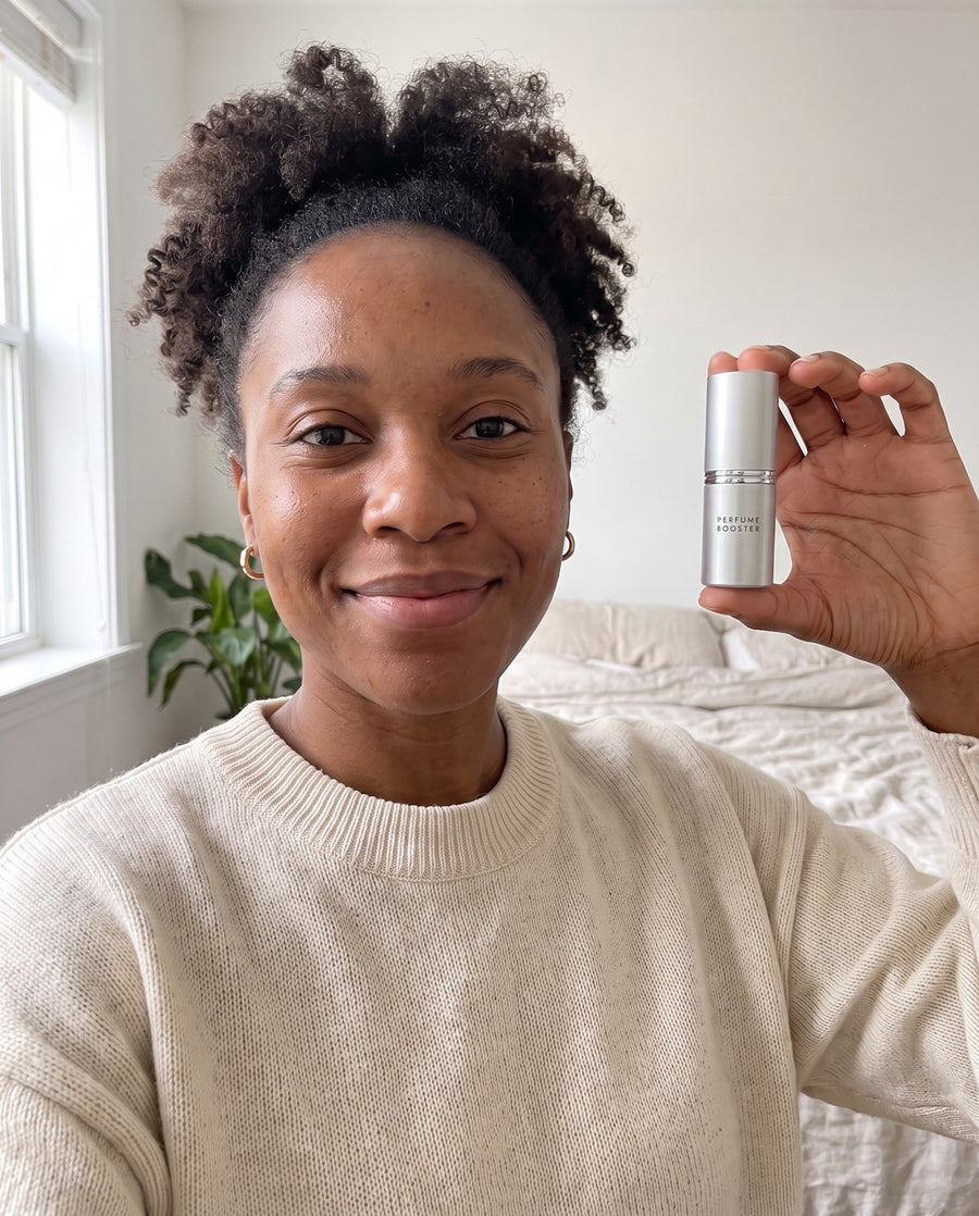 Woman holding a Perfume Booster stick at home