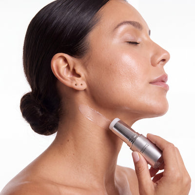 Woman swiping the Perfume Booster stick on her neck